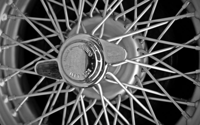 An image of an old car wheel with spokes