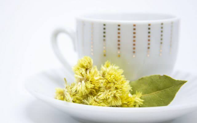 A picture of a teacup and flowers