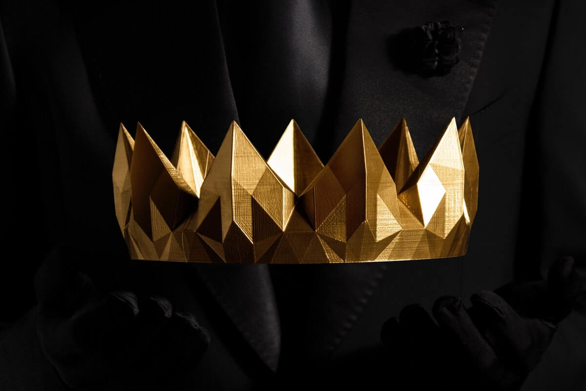 A picture of a golden crown on a black background